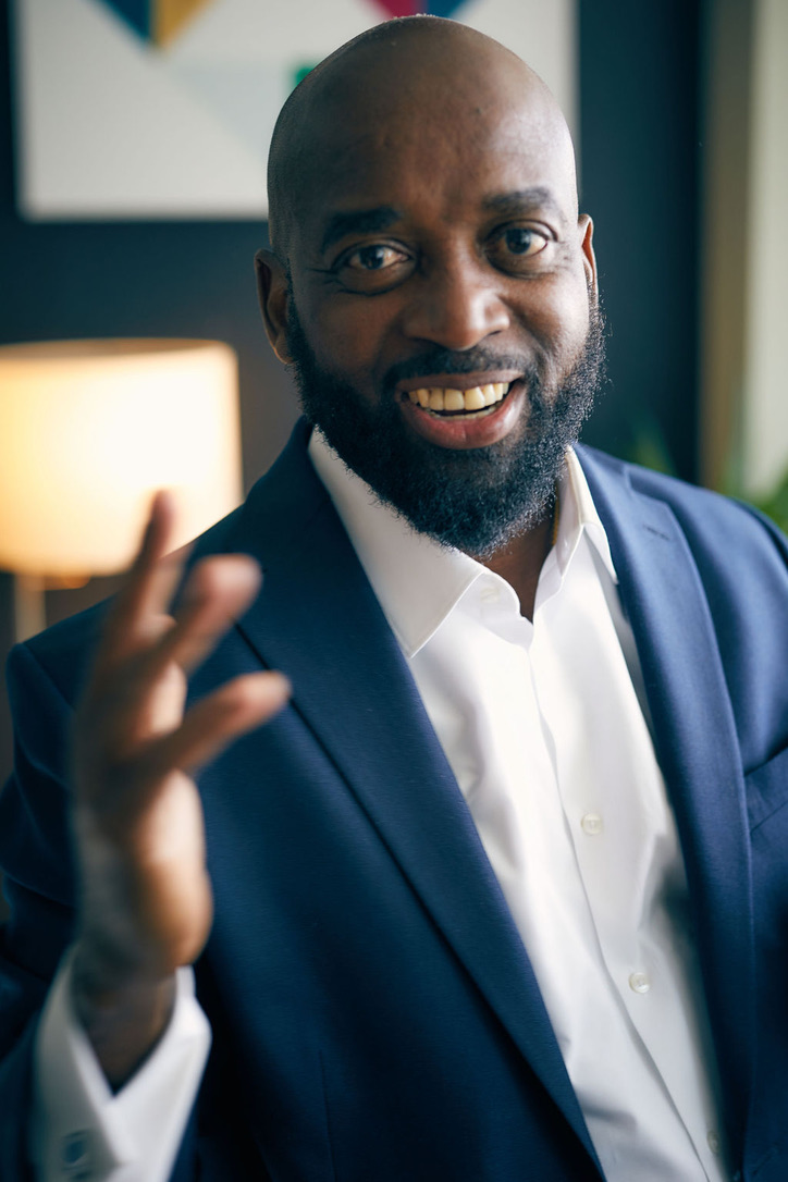 MuRay smiling, with one hand extended